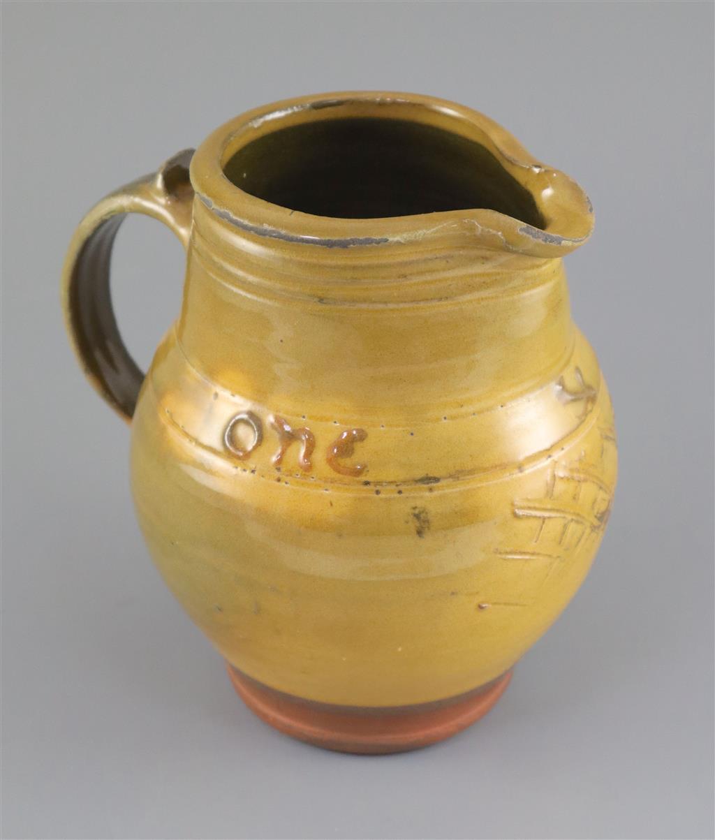 Bernard Howell Leach (1887-1979). A mustard-glazed slipware jug, 17cm high